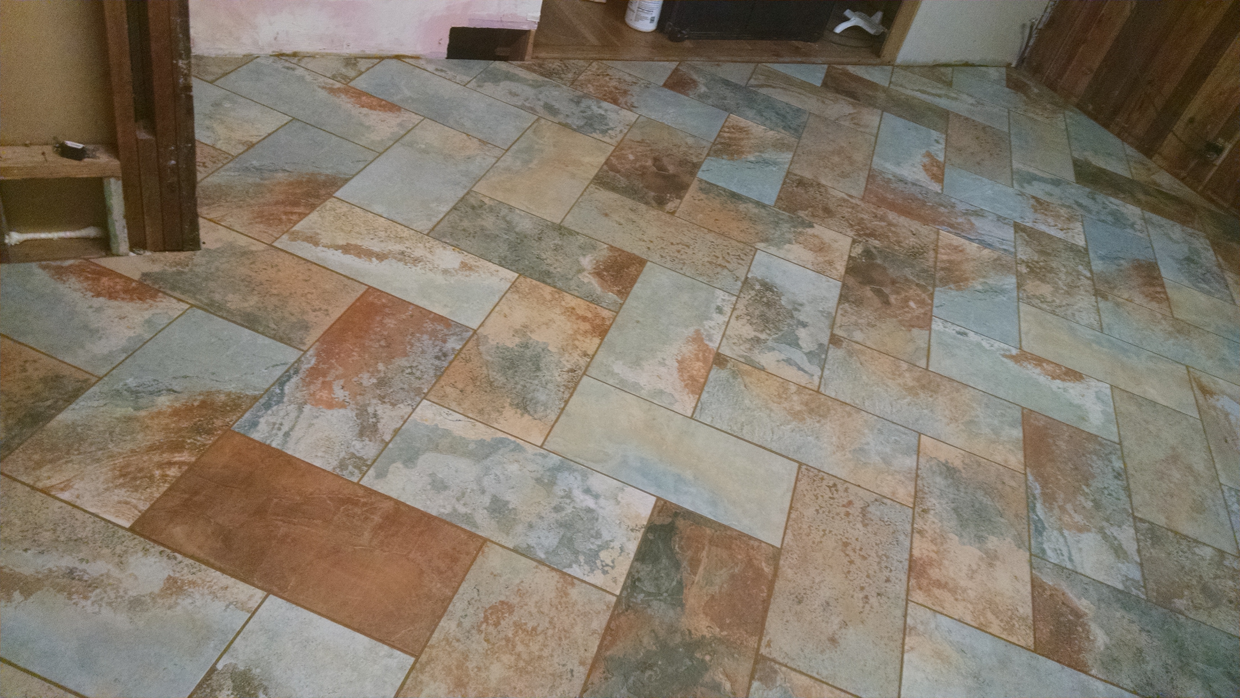 Kitchen floor tiled with colorful slate tiles